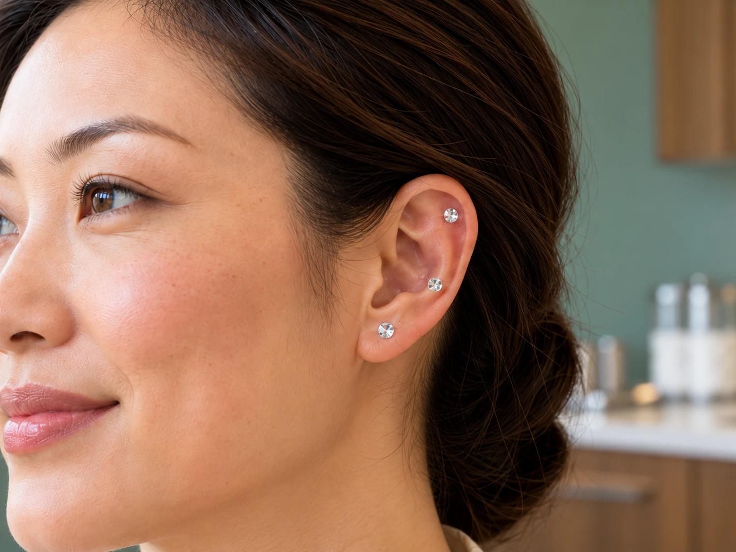 Same woman with clear faceted adhesive crystals on the outer ear